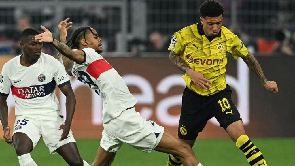 PSG defenders tackling Dortmund's Jadon Sancho